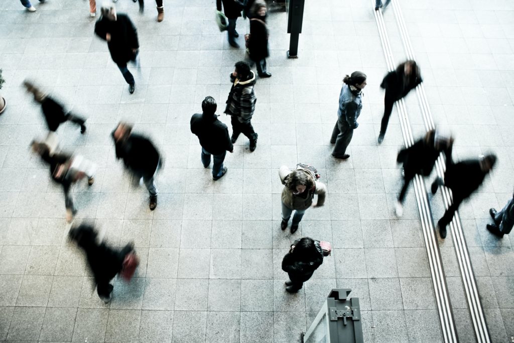 A birdseye view of a busy public place with lots of people walking around